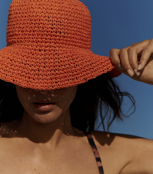 Woman in beach hat in the sun