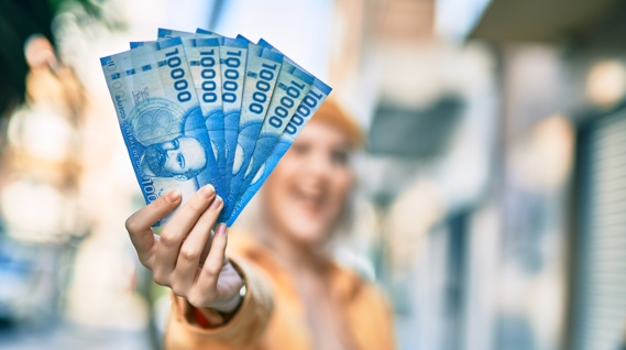 Girl holding Chilean peso notes