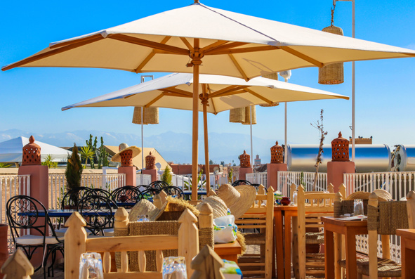 Moroccan rooftops in Marrakech, chairs, tables and sun umbrellas