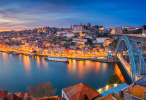 Porto, Portugal. Panoramic cityscape image of Porto, Portugal with the famous Luis I Bridge and the Douro River during dramatic sunset.