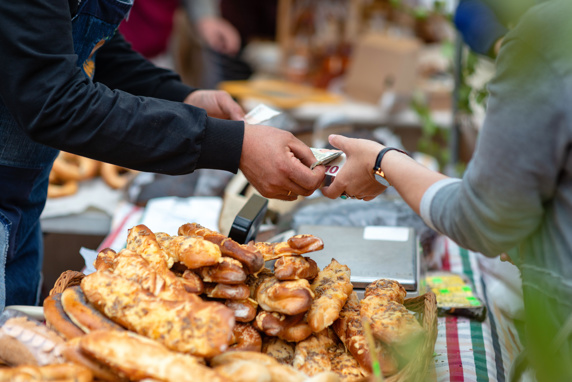 Market stall with person paying in euros
