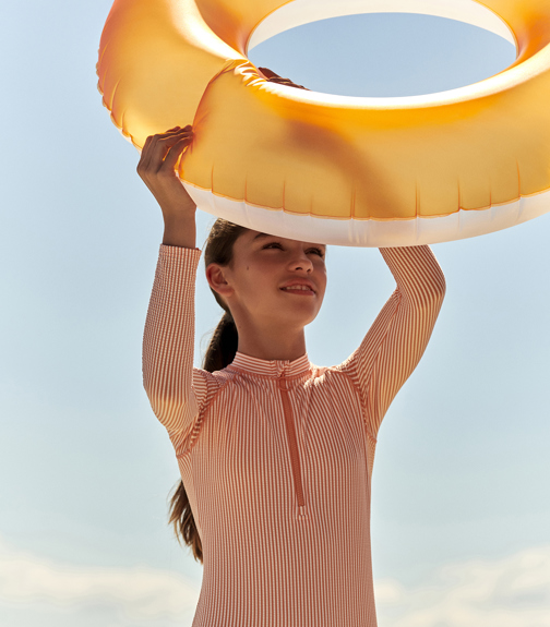 Young girl holding inflatable ring